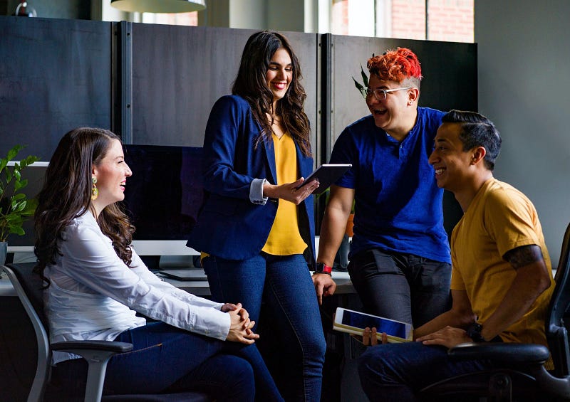 four people laughing together