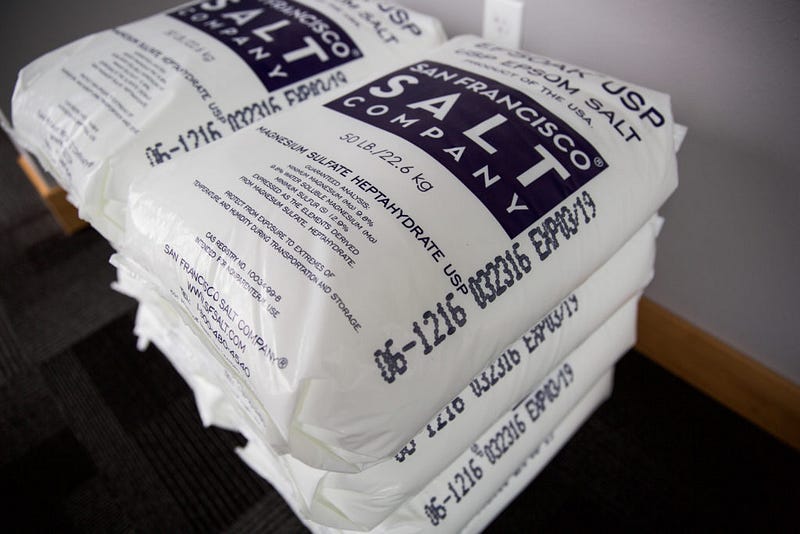 Oversized bags of salt line the hallway at Still Life — a reminder that 1,200 pounds of salt goes into each float tank. Epsom salt contains very high amounts of magnesium sulfate. This greatly boosts the levels of serotonin in the body; resulting in a calm mind and relaxed state of being. 