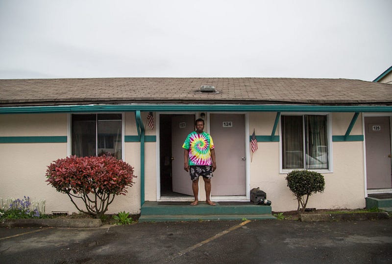 Jamerson poses for a photo outside his room on April 14, 2016 at the Shamrock Motel next to the Bellingham airport