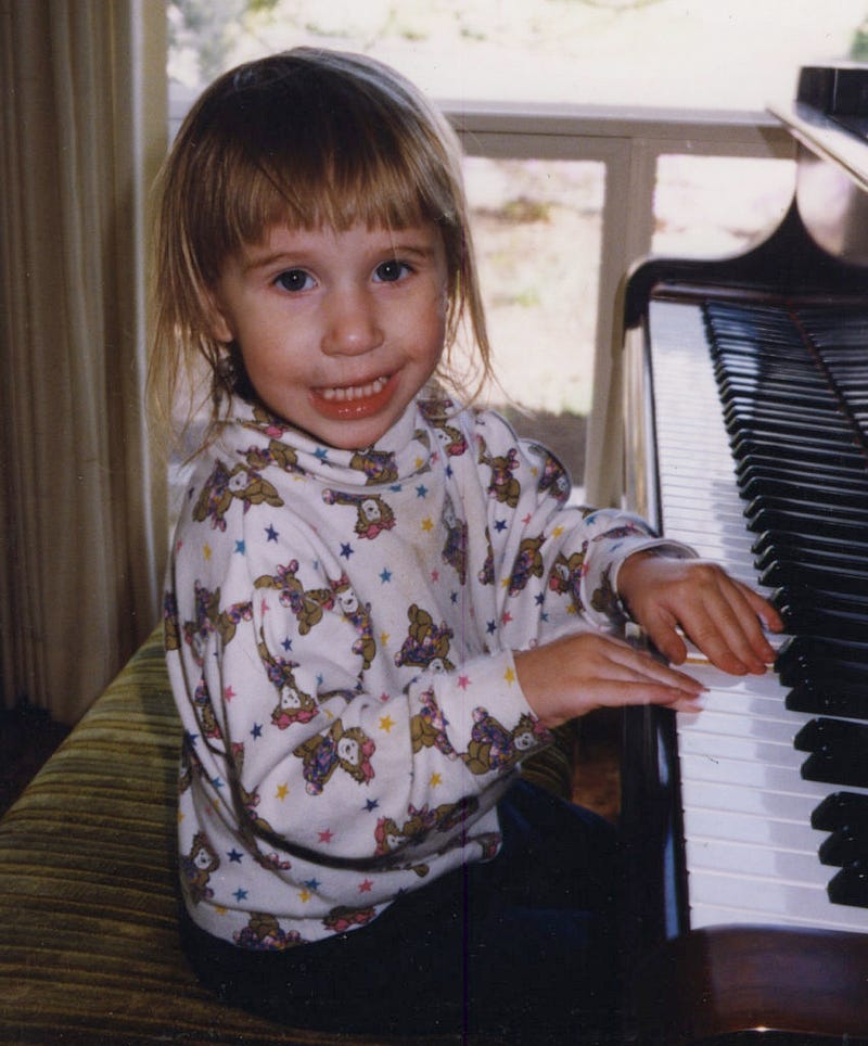 Rebekah Way plays piano as a child. Photo courtesy of Rebekah Way.