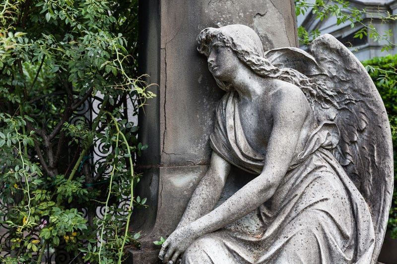 pensive angel at grave.