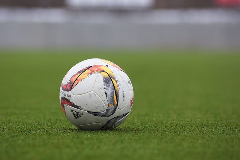 A football on the grass on a field