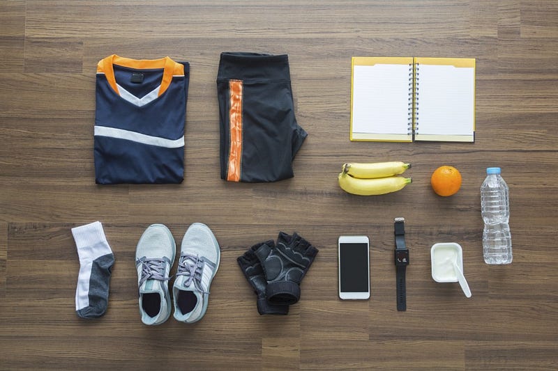 Sport clothes and accessories on a wooden background, View from above