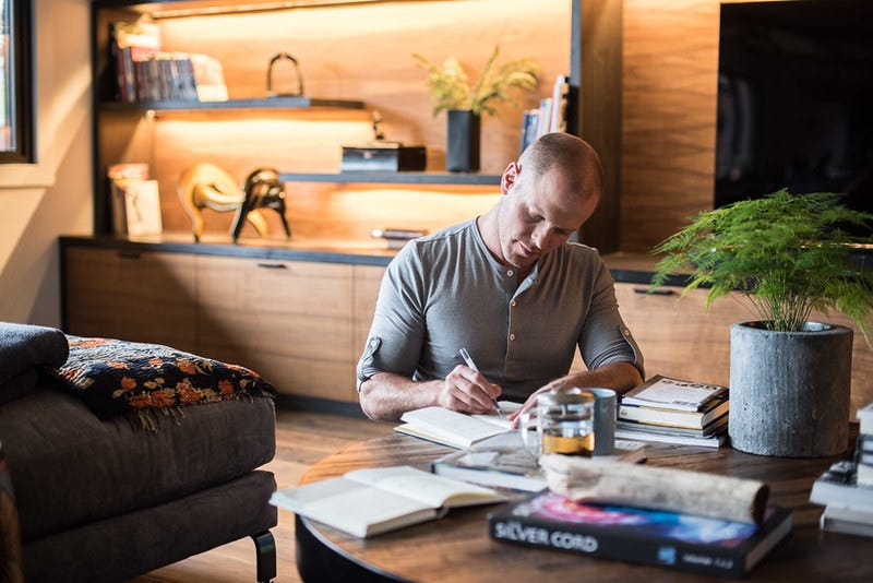 Tim Ferriss writing on his journal.