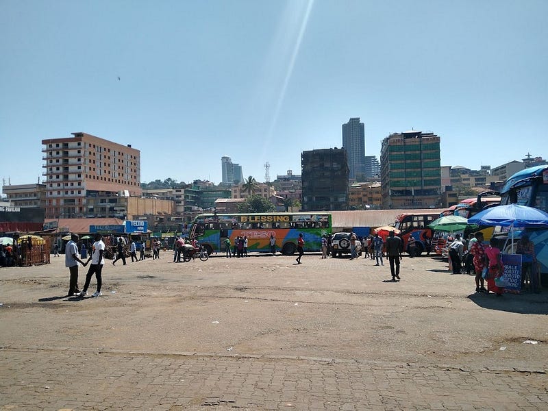 Pedestrians, bodas, and cars all converge at the Namayiba Bus Park in Kampala. Credit: Tom Courtright.