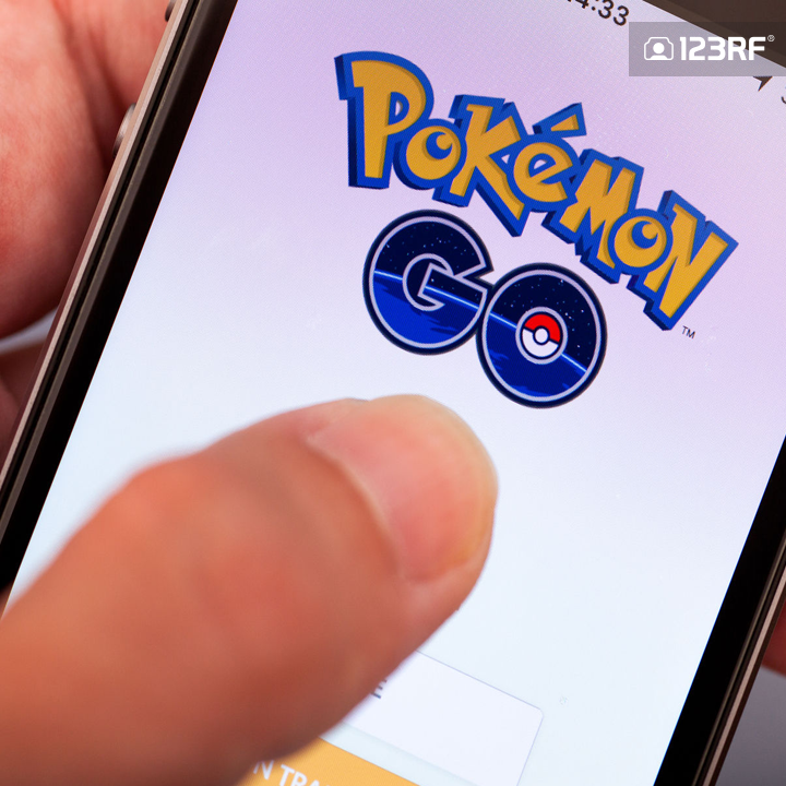Stock Photo - Tambov, Russian Federation - July 13, 2016 Person hand starting Pokemon Go application on apple iPhone5s. Studio shot.