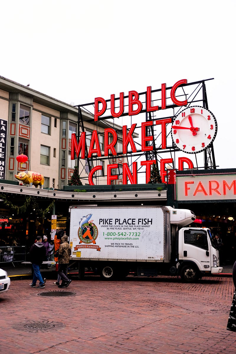 Street view of food market with big a big red sign that reads public market center