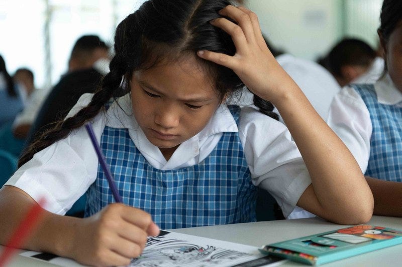 Young student frowning as she works on an assigment