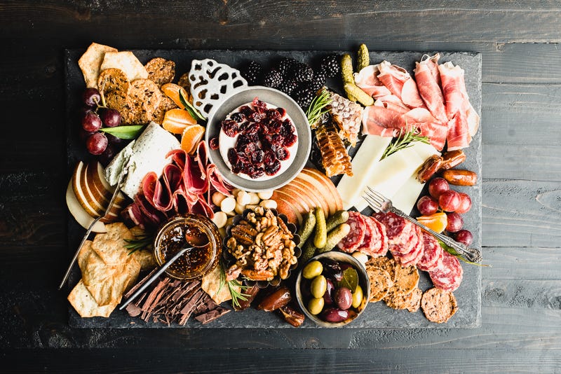 gluten-free charcuterie board with meat crackers cheese and fruit
