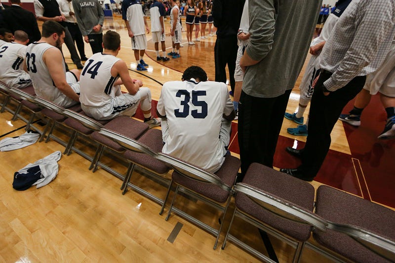 Taking a final moment to himself, Jeff sits quietly on the bench, waiting to hear his name, as the announcer calls out each starter for the Western Washington University Vikings.