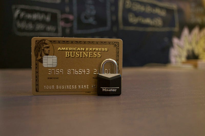 Gold American Express card on desk.