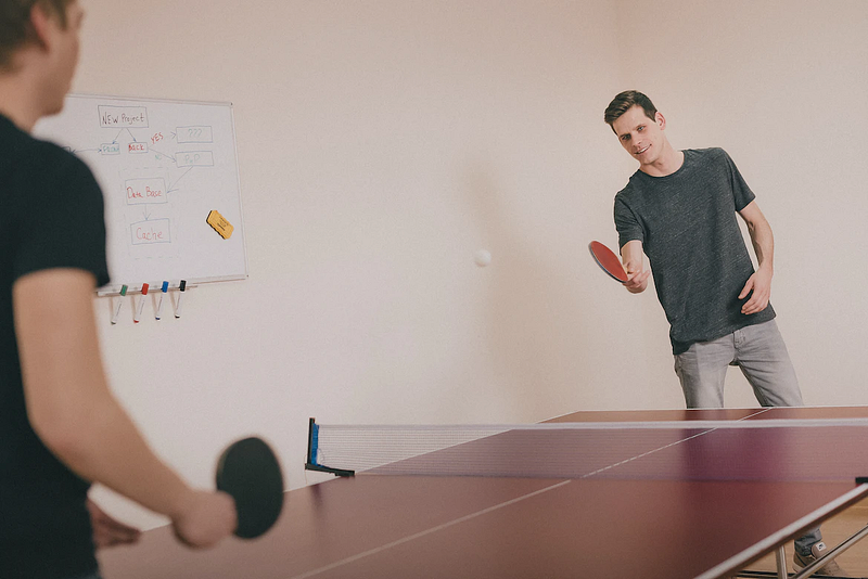 two persons playing table tennis