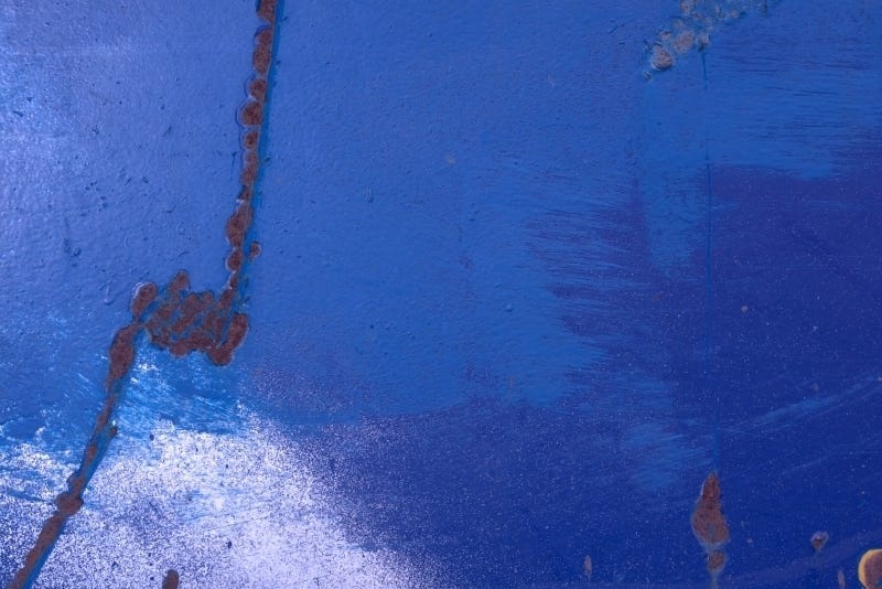 Abstract photograph of blue paint and rust, for healing