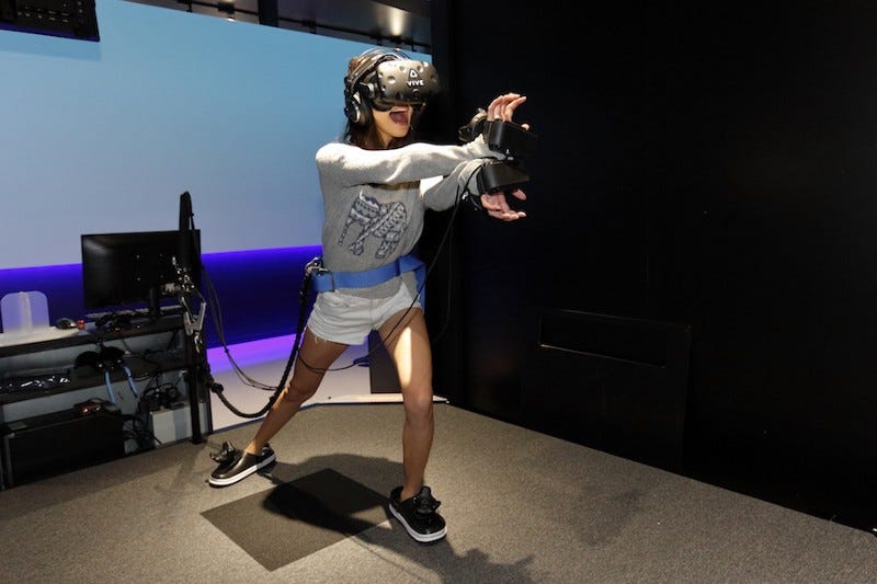 A girl tries to do the Kamehamaha from Dragon Ball at VR Zone Shinjuku in Tokyo