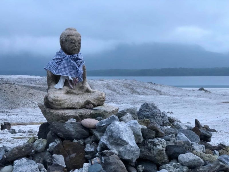 A solemn Buddhist statue sits against a bleak background at Aomori Prefecture’s Mt. Osore (Osorezan)
