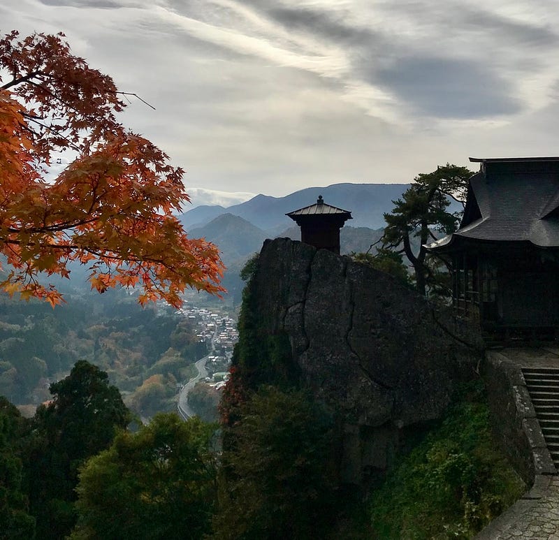 Iconic photo of Yamadera temple silhouetted against a darkening sky.