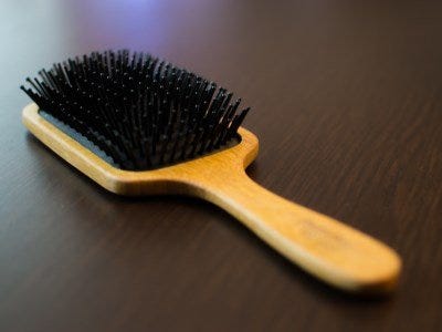 A paddle style hairbrush on a table