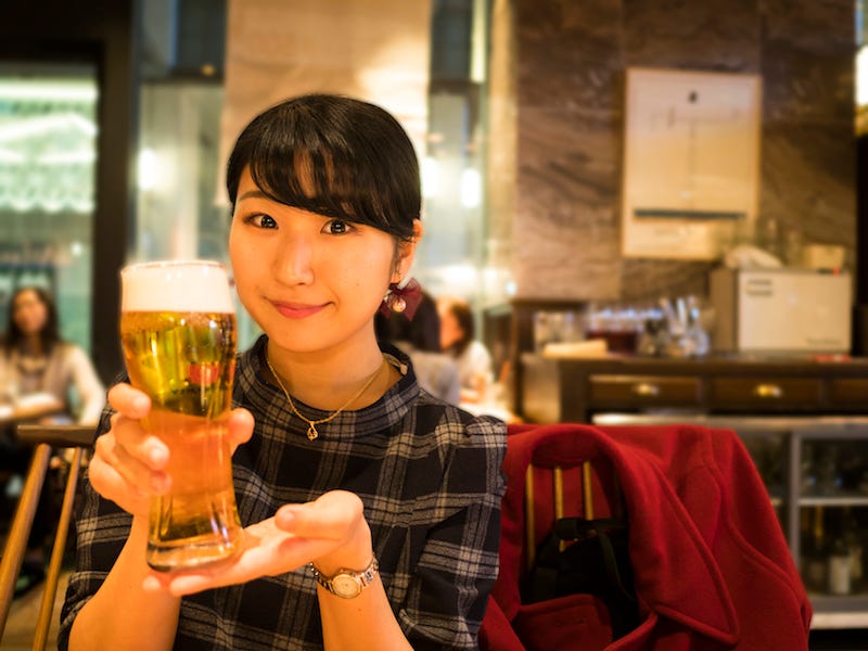 A Japanese woman enjoys her beer that she doesn’t need to tip for
