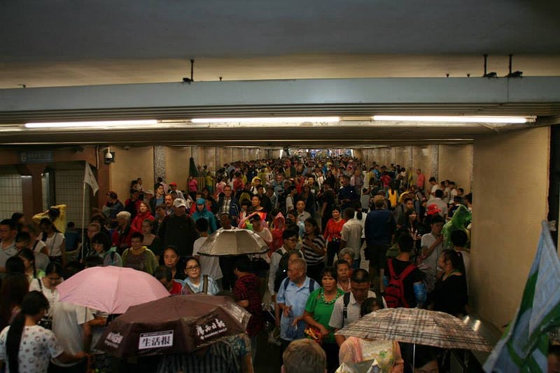 A packed crowd of people in an underpass in Beijing