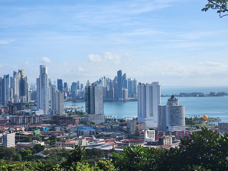 City skyline with skyscrapers along an oceanfront.