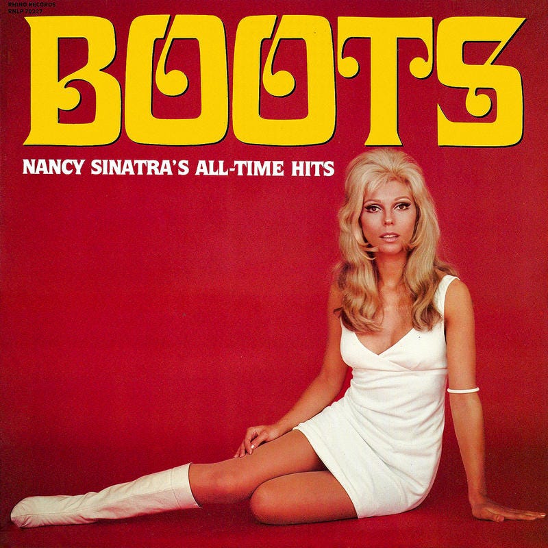 A red vinyl cover with the title “Boots” in yellow with Nancy Sinatra sitting down in a white dress with go-go boots on.