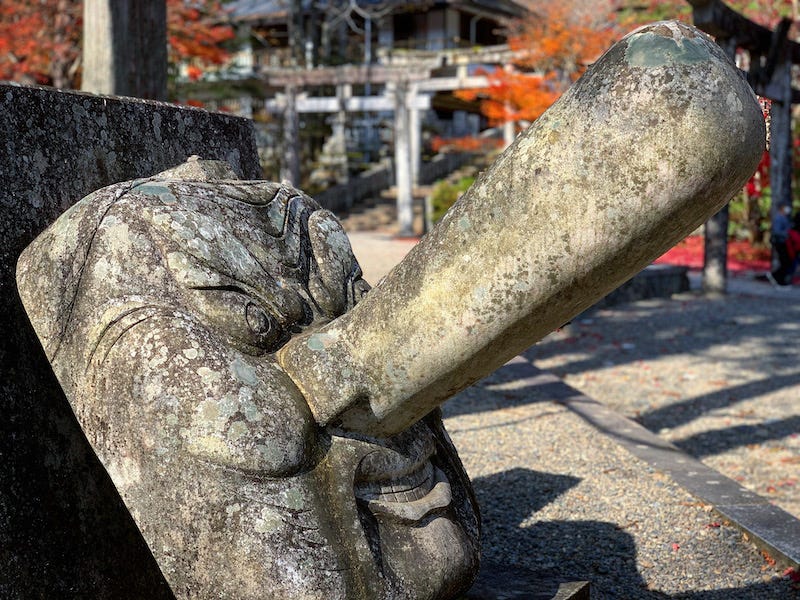 A stone tengu face at Furumine Shrine