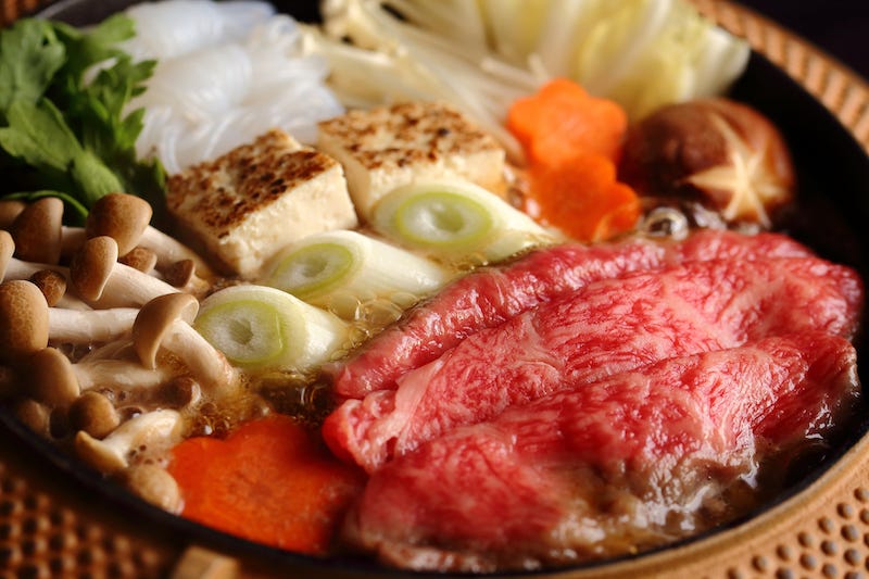 Some Japanese wagyu beef in a sukiyaki hot pot along with other veggies
