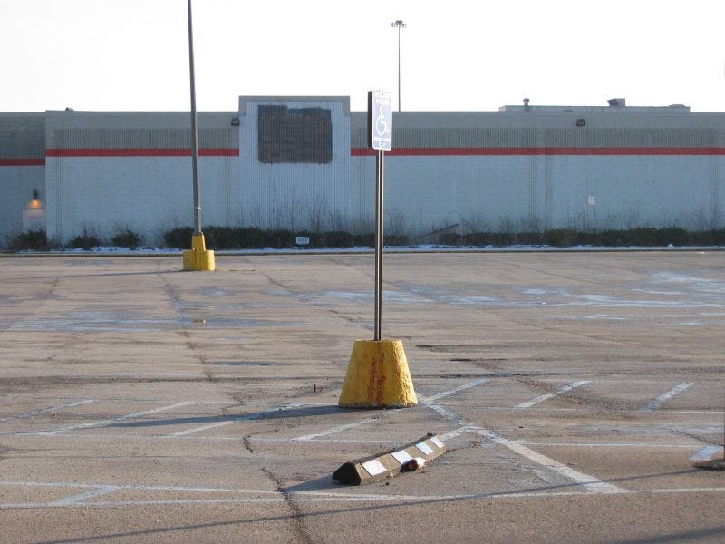 A deserted shopping mall and parking lot