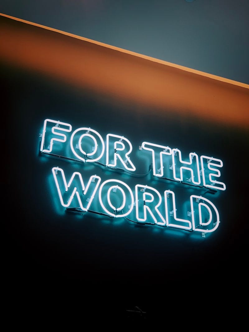 A neon sign that says FOR THE WORLD