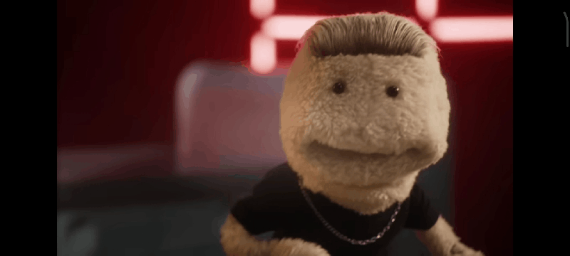 A GIF of a puppet looking like he’s doing something suggestable