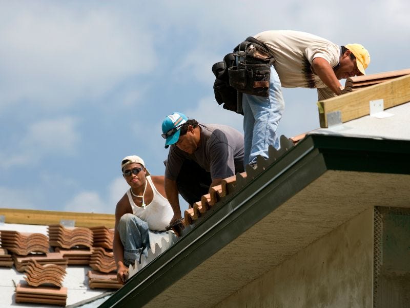 Roofing professionals at work.