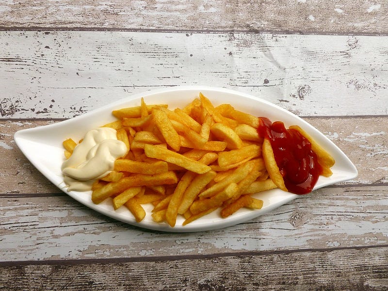French fry chip in a white plate with Ketchup and mayonnaise sauce