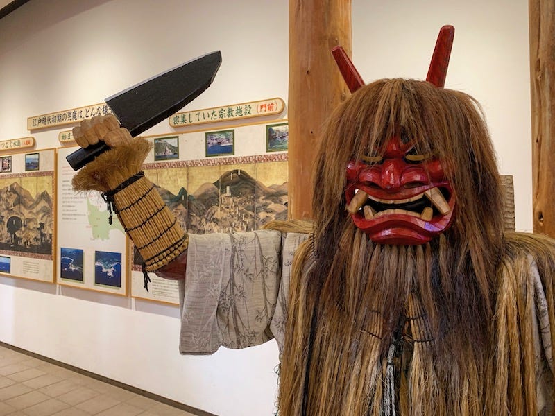 A manikin dressed as a Namahage wields a knife on Akita Prefecture’s Oga Peninsula