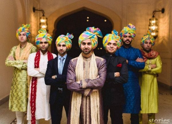 Grooms wearing bright leheriya print safas