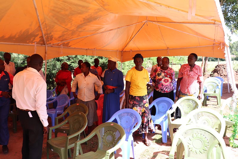 Village Enterprise business savings group members under their tent