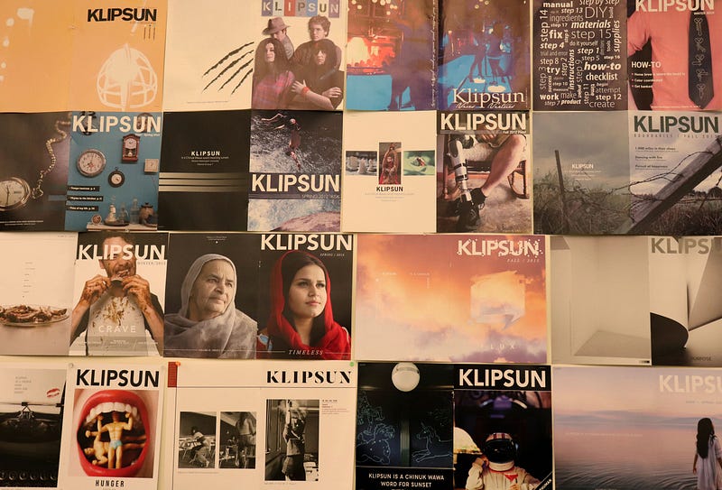 16 different magazine covers. Key covers show a man eating ferociously and messily, two women wearing headscarves, a person wearing a prostetic leg, and a woman standing in a lake (the cover from Wake).