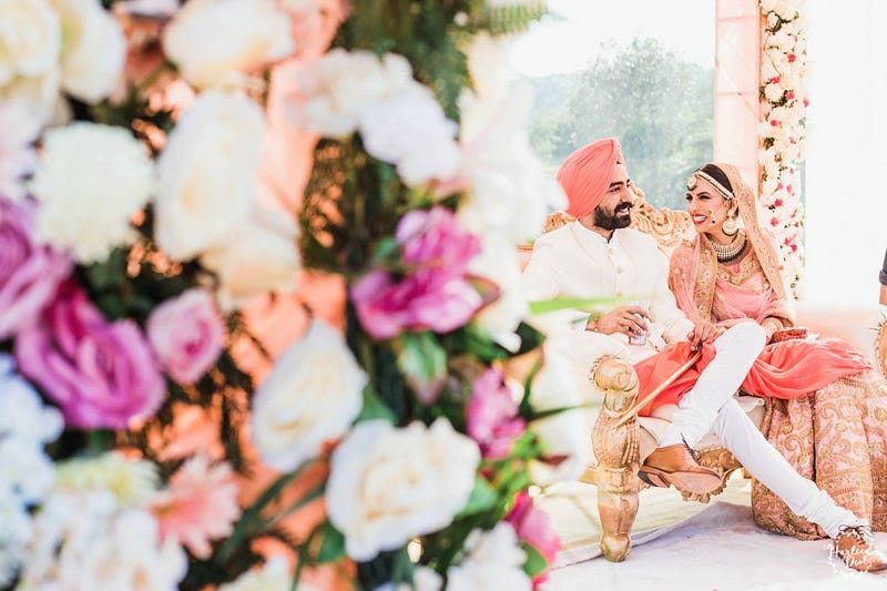 Bride & Groom wearing Salmon Pink colored outfits