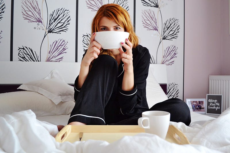 A woman having breakfast in bed.