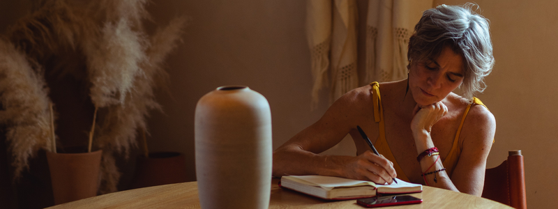 image of a woman writing in a notebook