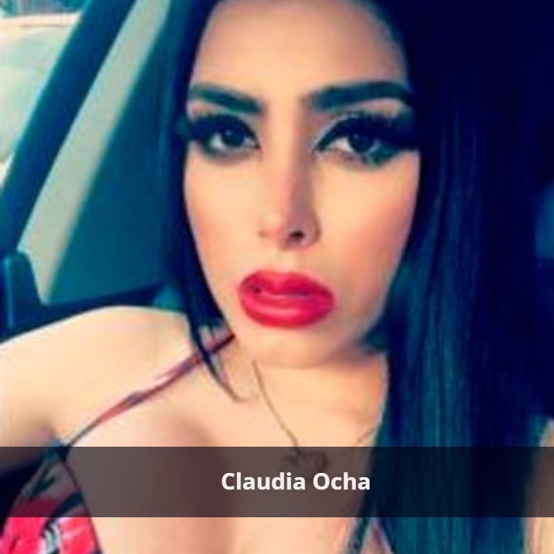 Claudia Ocha sitted a car wearing a red lipstick