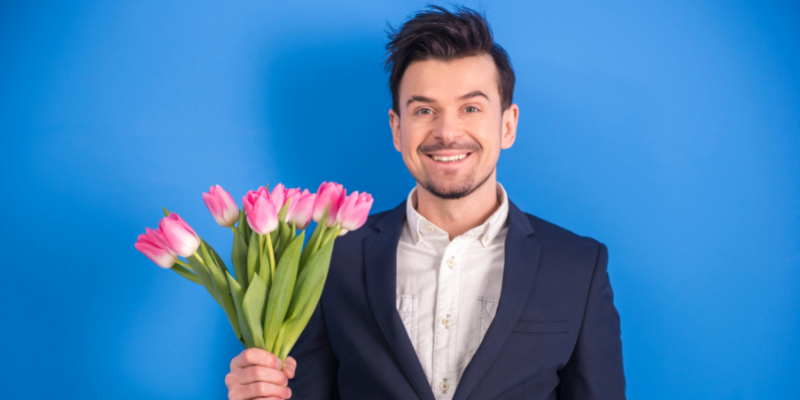 Man with flowers — Treating Your Partner Well Isn’t a Favor