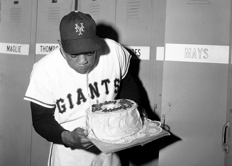 Willie Mays blowing out candles on his birthday cake