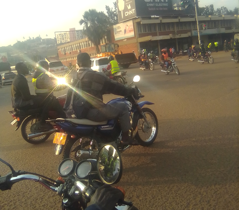 Motorist at Jinja road traffic lights on a police motorcycle not wearing any protective gear. Credit: Kalungi James.