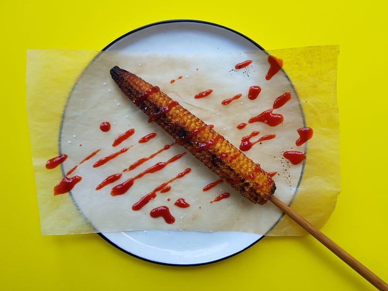 Baked Baby Corn Lollipop served on a plate