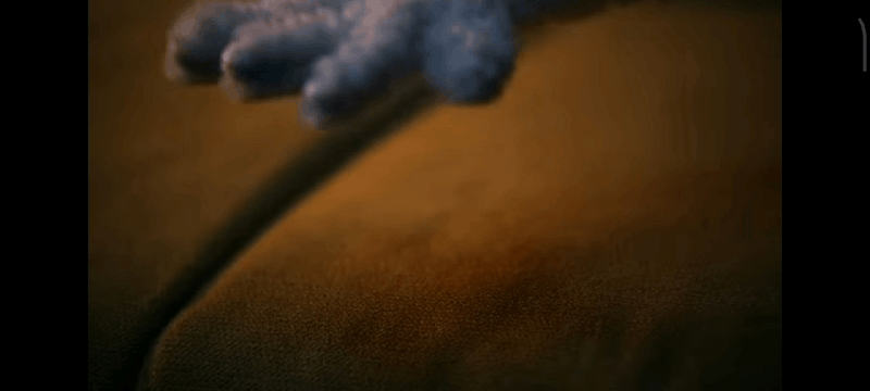A GIF of a puppet’s hand slapping the sofa