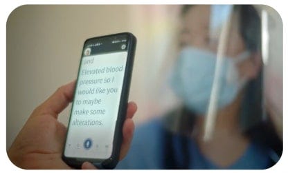Ava App captions at the doctor’s office showing a patient and a medical professional.