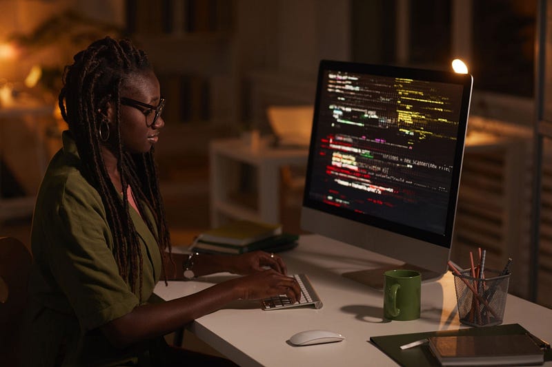 Female African-American IT Developer Writing Code. | @SeventyFour