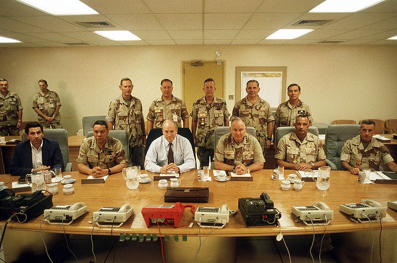Military and defense leaders in an office leading up to the Gulf War.