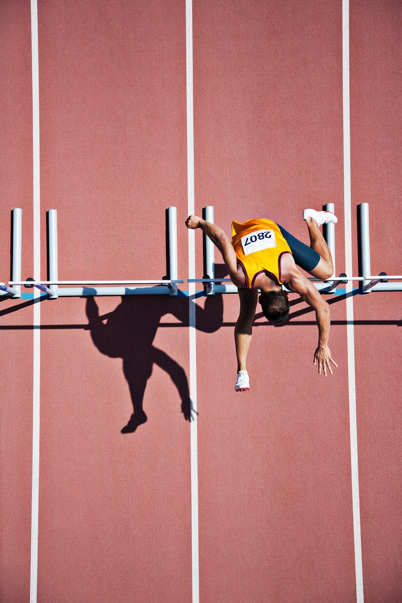 Sprinter jumping over hurdles.