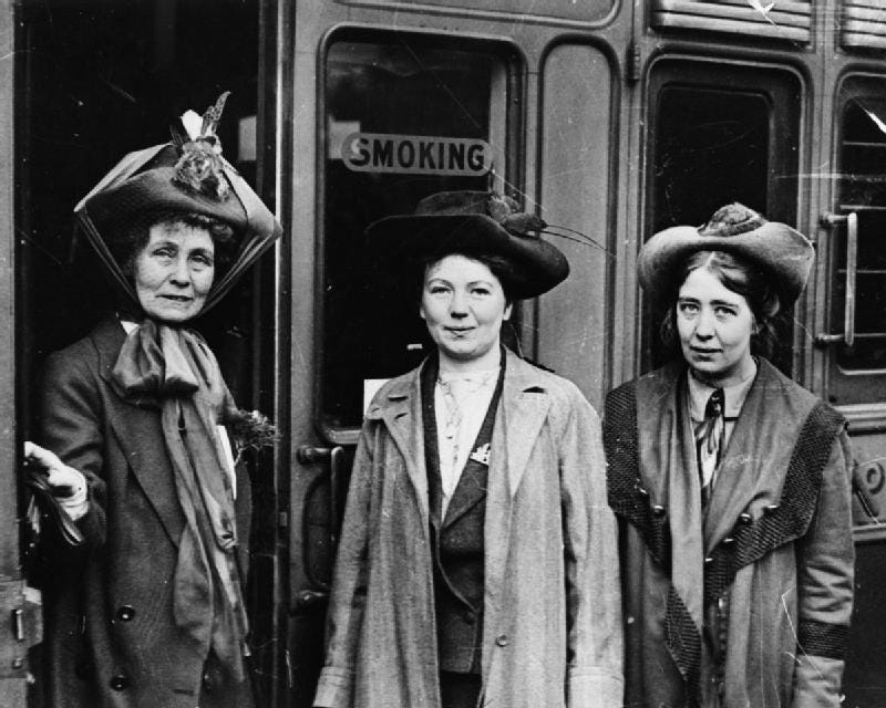 Emmeline, Christabel and Sylvia Pankhurst stood outside of a building